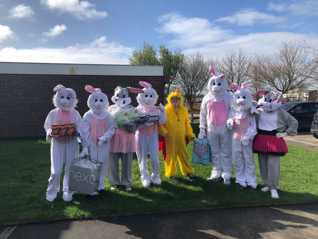 A group of local residents dressed up as Easter bunnies, holding chocolate eggs